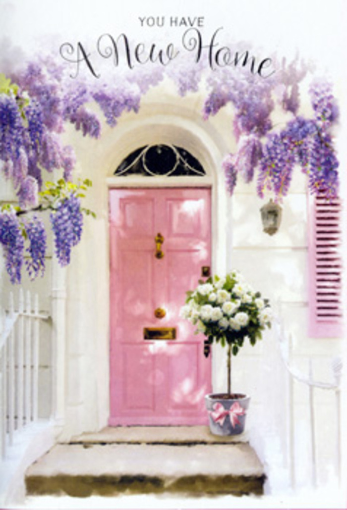 Set against the backdrop of a classic London façade, this doorway scene feels like a soft exhale at the end of a moving day, when boxes are stacked inside and someone has finally remembered the flowers. The central focus is a pale pink front door, its muted tone both cheerful and calming, standing out gently from the clean white walls around it. The paint is smooth, almost chalky in appearance, catching the daylight in subtle gradients that add depth and warmth. To one side, a pastel shutter repeats the same tender hue, visually tying the composition together. Above and around the doorway, mature wisteria spills down in lush cascades, its flower clusters a blend of lavender, lilac, and soft purple. The blooms hang in generous strands, some reaching almost to the top of the door, while fine green leaves weave through them, offering contrast and a sense of natural movement. On the doorstep, a simple grey tin bucket has been transformed into a work of floral art. It cradles a full bouquet of white and cream roses, each bloom fresh and plush, petals curling gently outwards like layers of silk. Sprigs of soft green foliage are interspersed throughout, breaking up the ivory tones and giving the bouquet an effortless, hand-gathered charm. The bucket is cinched with a satin ribbon in a delicate pink shade, tied into a bow with trailing ends that rest lightly against the metal. Together, door, wisteria, and roses create an atmosphere of optimism and new beginnings, ideal for a housewarming floral gift delivered anywhere across London. The image suggests that quiet, intimate moment when a new space first feels like it might, with time and care, become home.